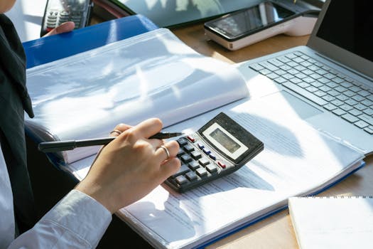 a person creating a budget on a computer